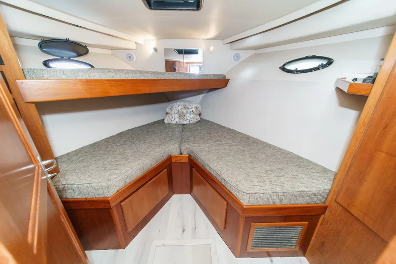 Slide: The Image of Cozy cabin interior of 1991 Californian 55 Cockpit Motor Yacht with wooden accents and twin beds. - 32