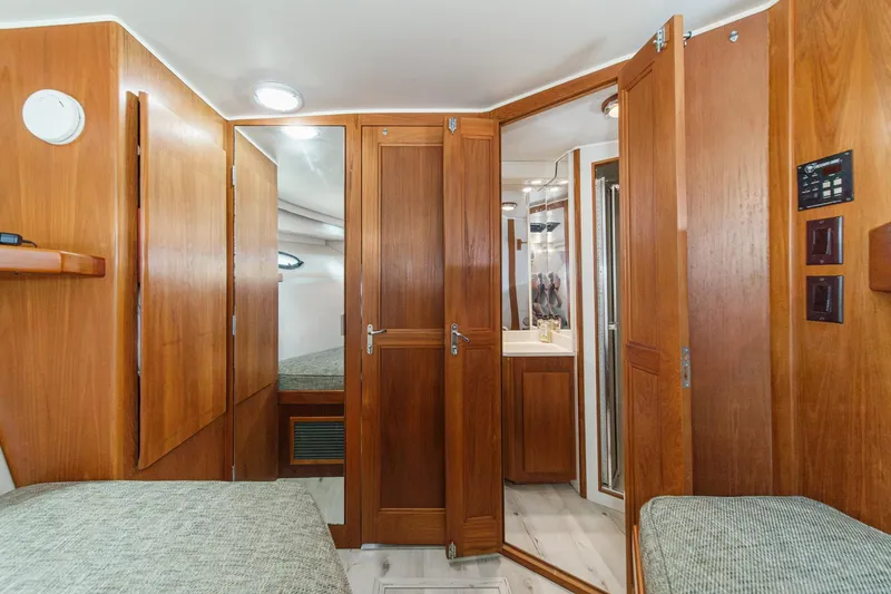 Slide: The Image of Interior of 1991 Californian 55 Cockpit Motor Yacht with wooden cabinetry and cozy sleeping area. - 33