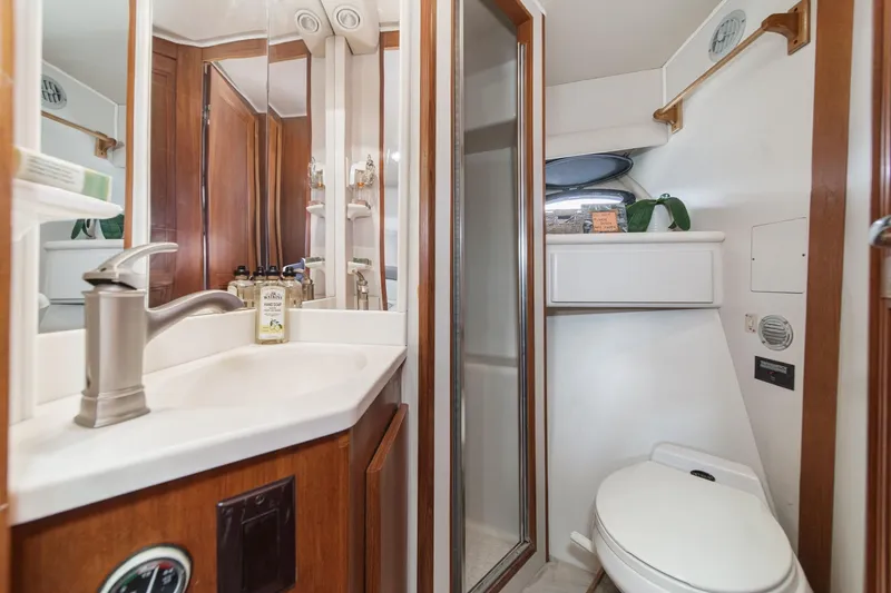 Slide: The Image of Bathroom interior of 1991 Californian 55 Cockpit Motor Yacht with sink, mirror, and toilet. - 34