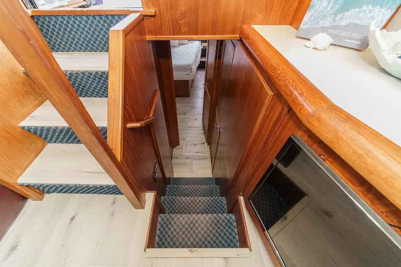 Slide: The Image of Interior view of 1991 Californian 55 Cockpit Motor Yacht with wooden stairs and cozy cabin. - 35