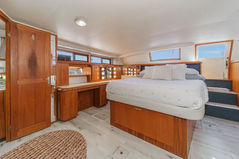 Slide: The Image of Luxurious 1991 Californian 55 Cockpit Motor Yacht bedroom with elegant wood finishes. - 36
