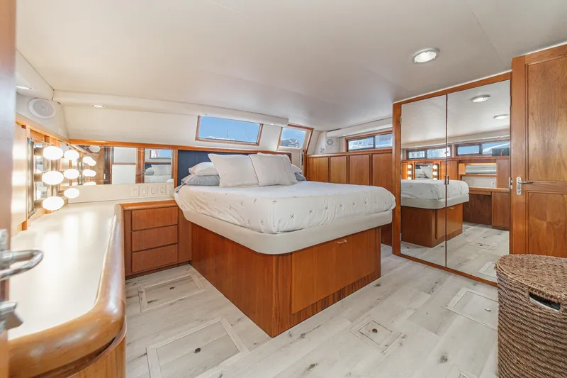 Slide: The Image of Luxurious bedroom interior of 1991 Californian 55 Cockpit Motor Yacht with wood accents and mirrors. - 38
