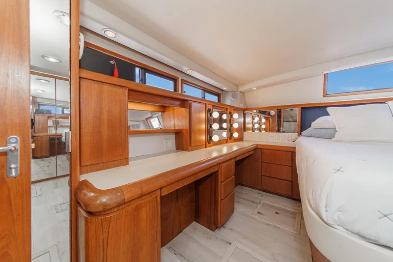 Slide: The Image of Luxurious 1991 Californian 55 Cockpit Motor Yacht bedroom with elegant wood furnishings and vanity. - 39