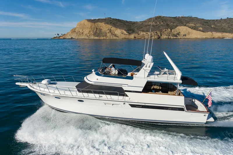 Slide: The Image of 1991 Californian 55 Cockpit Motor Yacht cruising near rocky coastline. - 4