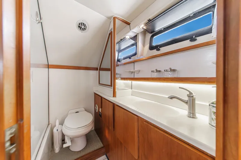Slide: The Image of Luxurious bathroom in 1991 Californian 55 Cockpit Motor Yacht with modern fixtures and wood accents. - 41