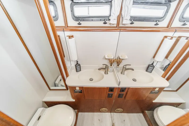 Slide: The Image of Luxurious bathroom in 1991 Californian 55 Cockpit Motor Yacht with dual sinks and elegant fixtures. - 45