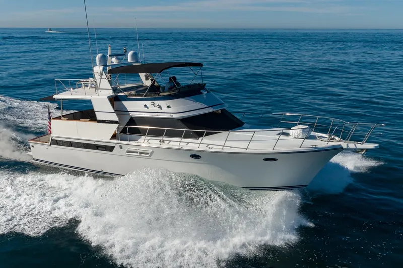 Slide: The Image of 1991 Californian 55 Cockpit Motor Yacht cruising on open water. - 5