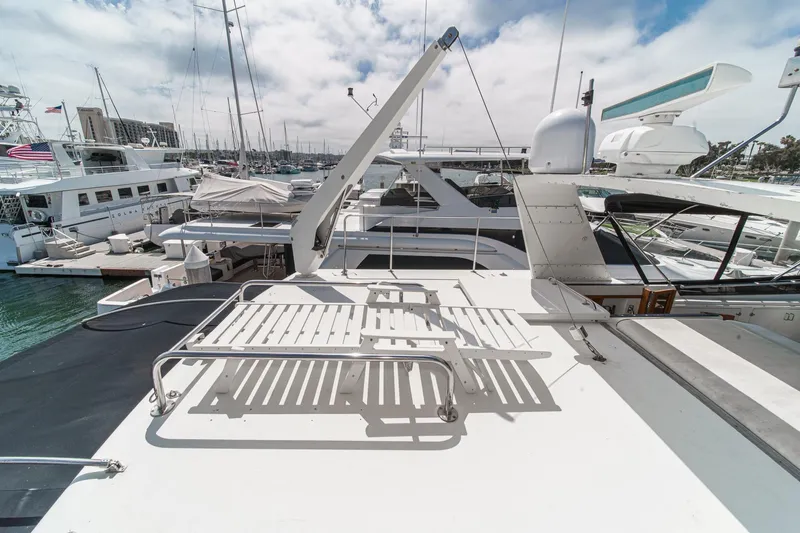 Slide: The Image of 1991 Californian 55 Cockpit Motor Yacht docked in a marina under a partly cloudy sky. - 52