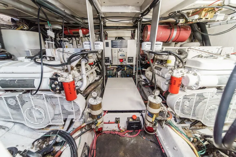 Slide: The Image of Engine room of a 1991 Californian 55 Cockpit Motor Yacht, showcasing dual engines and mechanical systems. - 53