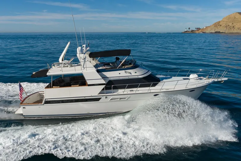 Slide: The Image of 1991 Californian 55 Cockpit Motor Yacht cruising on open water. - 6