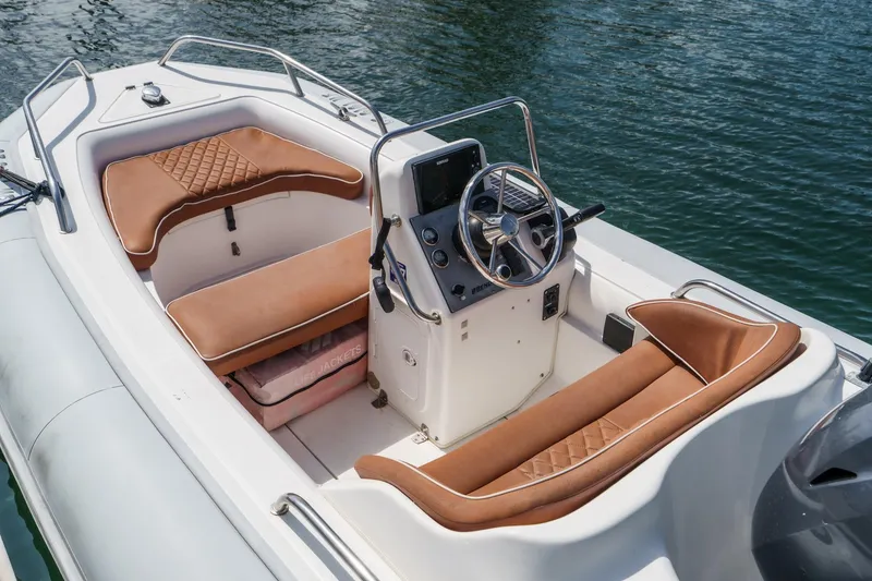 Slide: The Image of 1991 Californian 55 Cockpit Motor Yacht interior with brown seating and steering console. - 60