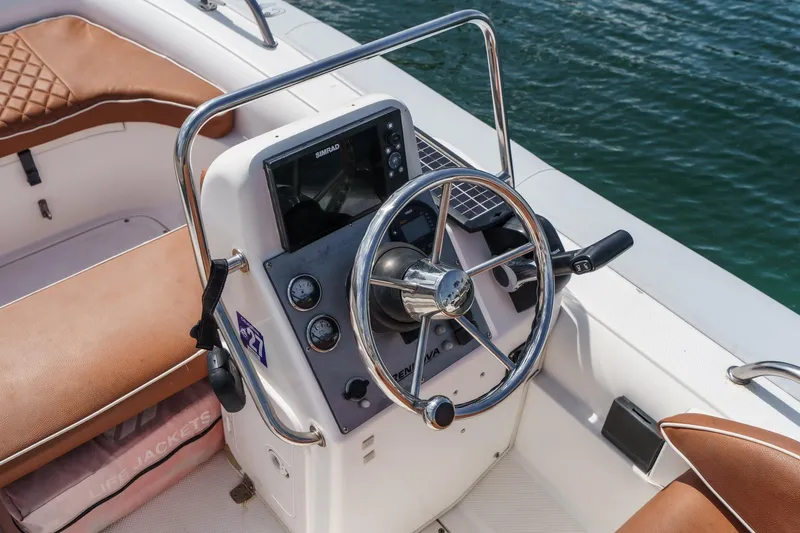Slide: The Image of Steering wheel and controls of a 1991 Californian 55 Cockpit Motor Yacht. - 61