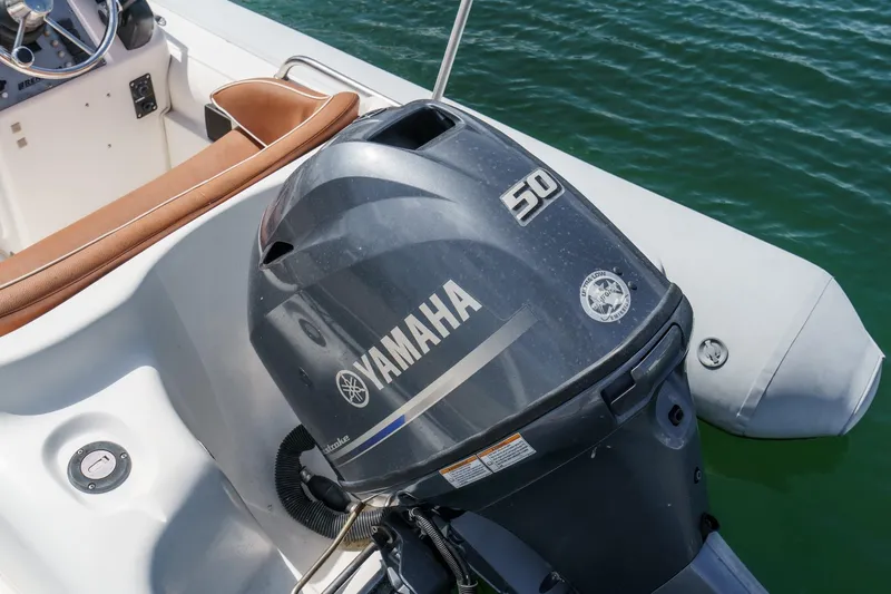 Slide: The Image of Yamaha 50 outboard motor on 1991 Californian 55 Cockpit Motor Yacht, docked on water. - 63