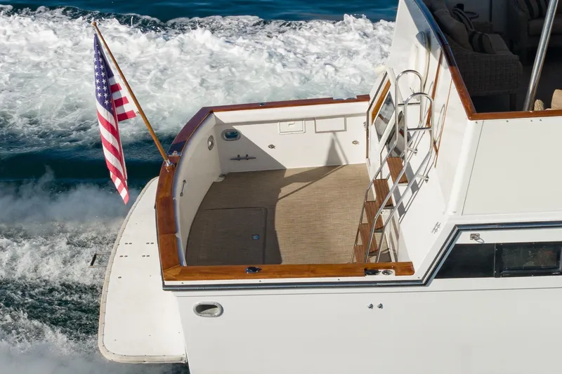 Slide: The Image of 1991 Californian 55 Cockpit Motor Yacht cruising with American flag. - 7