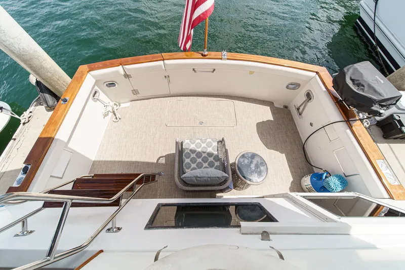 Slide: The Image of 1991 Californian 55 Cockpit Motor Yacht with spacious deck, seating, and American flag. - 8