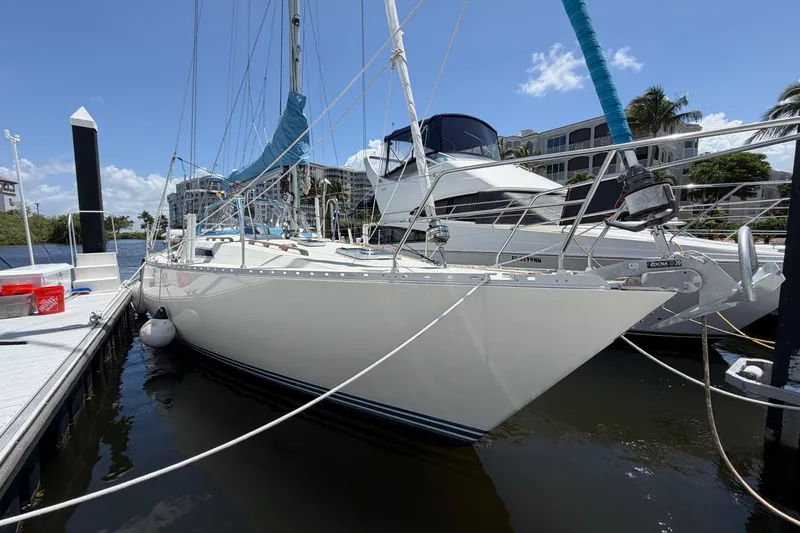 Slide: The Image of 1987 Moody 376 sailboat docked at marina under clear blue sky. - 2