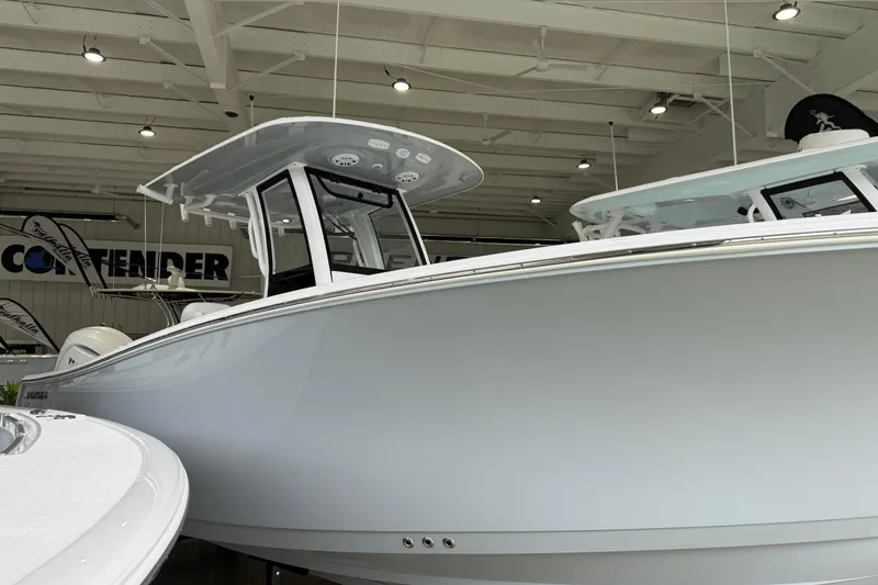 The Image of 2026 Sportsman Open 252 Center Console boat displayed in a showroom. - 0