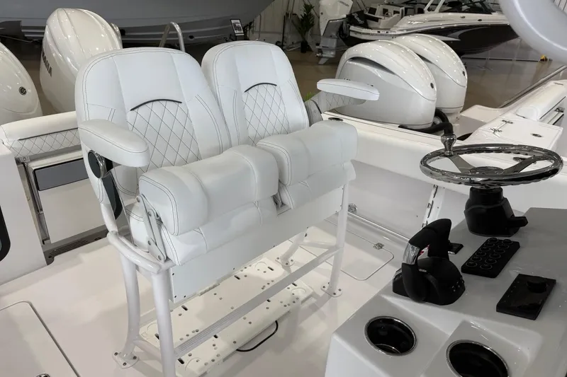Slide: The Image of 2026 Sportsman Open 252 Center Console boat interior with dual helm seats and steering wheel. - 10