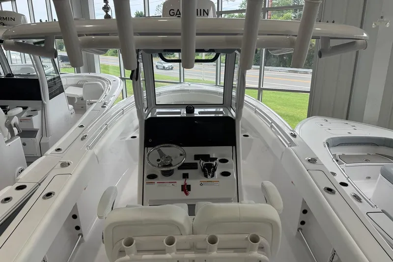Slide: The Image of 2026 Sportsman Open 252 Center Console boat interior with steering wheel and seating. - 12