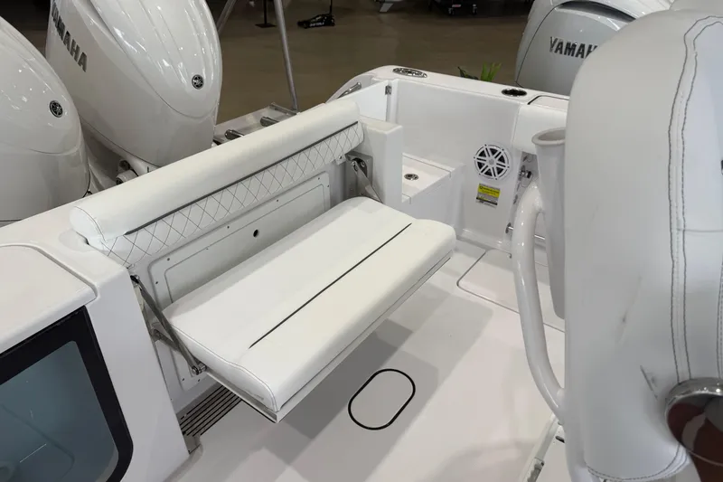 Slide: The Image of 2026 Sportsman Open 252 Center Console boat interior with white seating and Yamaha engines. - 14
