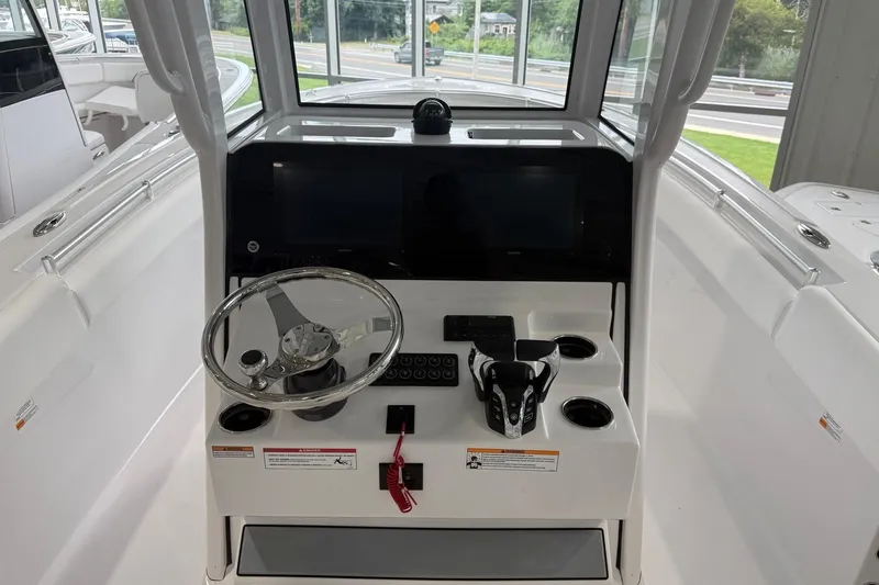 Slide: The Image of 2026 Sportsman Open 252 Center Console boat interior with steering wheel and control panel. - 3