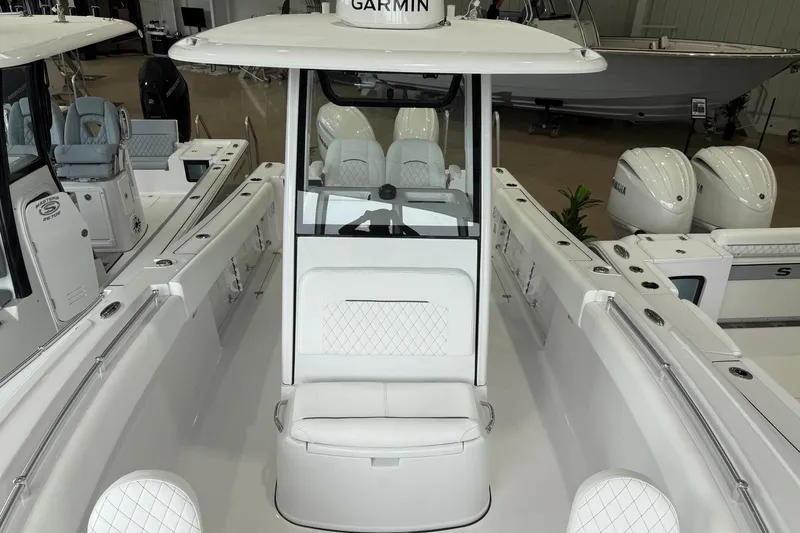 Slide: The Image of 2026 Sportsman Open 252 Center Console boat with white seating and Garmin equipment. - 5