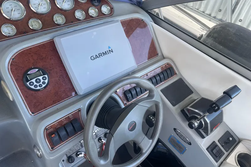 Slide: The Image of Control panel of a 2006 Bayliner 305 boat with Garmin navigation system. - 11