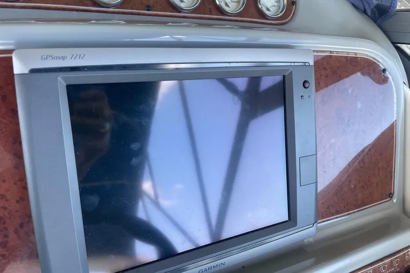 Slide: The Image of Garmin GPSmap 7212 on 2006 Bayliner 305 boat dashboard, featuring wood paneling. - 14