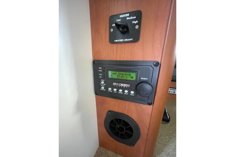 Slide: The Image of Control panel of a 2006 Bayliner 305 boat with heater and charging display. - 22