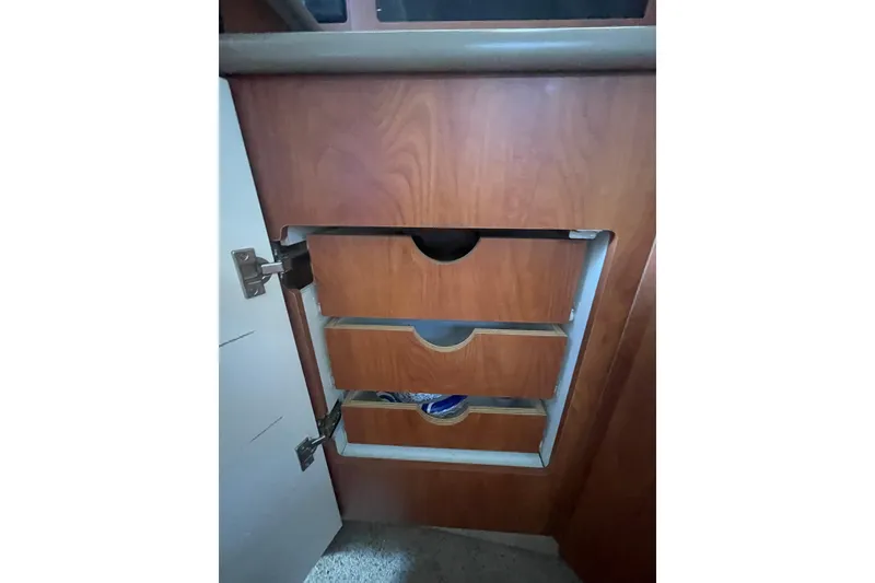 Slide: The Image of Interior storage drawers in a 2006 Bayliner 305 boat cabin. - 27