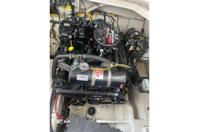 Slide: The Image of Engine compartment of a 2006 Bayliner 305 boat, featuring a Mercury 5.0 engine. - 32