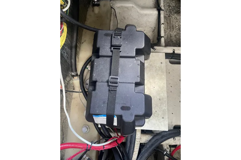 Slide: The Image of Battery compartment of a 2006 Bayliner 305 boat with secured black battery box. - 33