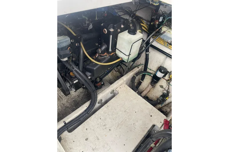 Slide: The Image of Engine compartment of a 2006 Bayliner 305 boat, showing various mechanical components. - 34