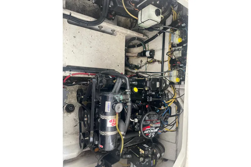 Slide: The Image of Engine compartment of a 2006 Bayliner 305 boat, featuring a Mercury engine. - 35