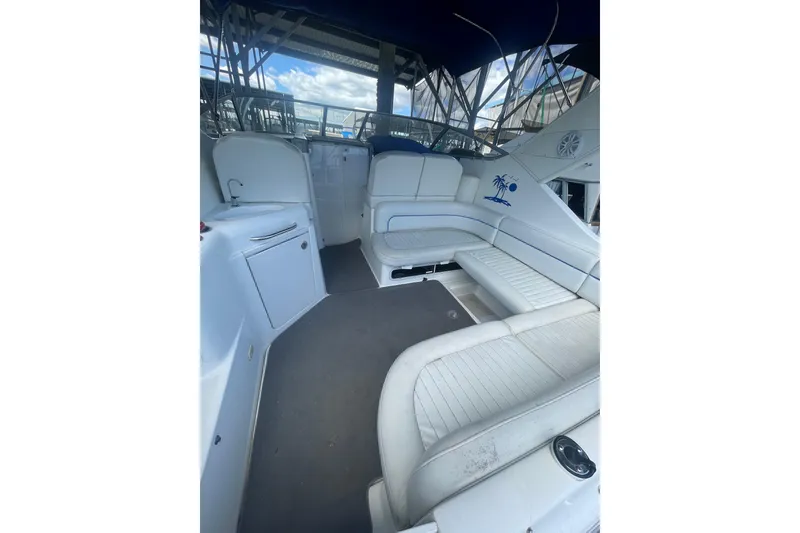 Slide: The Image of Interior of a 2006 Bayliner 305 boat with white seating and nautical decor. - 5