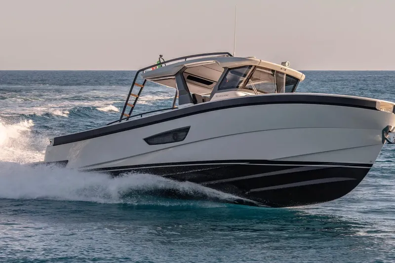 The Image of 2021 Bluegame BG 42 yacht cruising swiftly on open sea waters. - 0