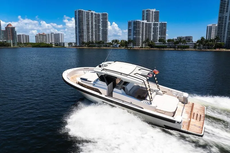 Slide: The Image of 2021 Bluegame BG 42 yacht cruising near city skyline on a sunny day. - 20