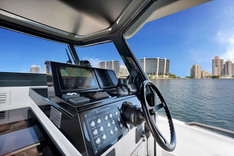 Slide: The Image of 2021 Bluegame BG 42 yacht helm with city skyline view. - 26