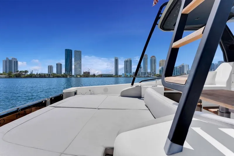 Slide: The Image of 2021 Bluegame BG 42 yacht with city skyline in the background. - 35