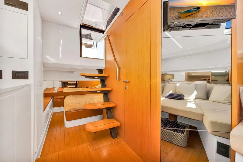 Slide: The Image of Luxurious interior of 2021 Bluegame BG 42 yacht with modern wood finishes and cozy seating. - 45