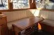 Slide: The Image of Interior of 1988 Grand Banks 46 Classic yacht with wooden table and beige seating. - 11