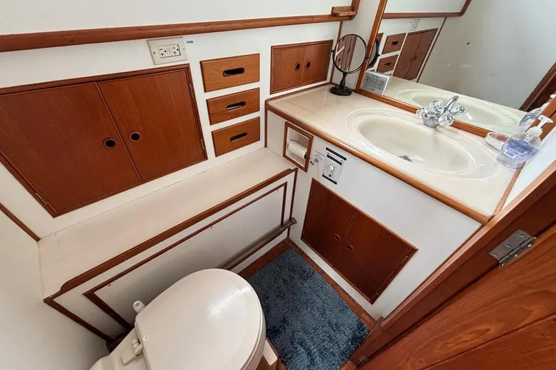 Slide: The Image of 1988 Grand Banks 46 Classic yacht bathroom with wooden cabinetry and sink. - 17
