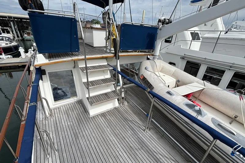 Slide: The Image of 1988 Grand Banks 46 Classic yacht deck with stairs and inflatable boat. - 18