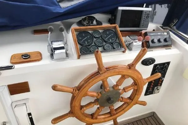 Slide: The Image of Helm of 1988 Grand Banks 46 Classic yacht with wooden wheel and navigation instruments. - 20