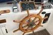 Slide: The Image of Wooden helm of 1988 Grand Banks 46 Classic yacht with navigation instruments. - 3