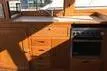 Slide: The Image of Interior of 1988 Grand Banks 46 Classic yacht with wooden cabinetry and stove. - 4