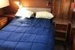 Slide: The Image of Cozy bedroom interior of 1988 Grand Banks 46 Classic yacht with blue bedding. - 8