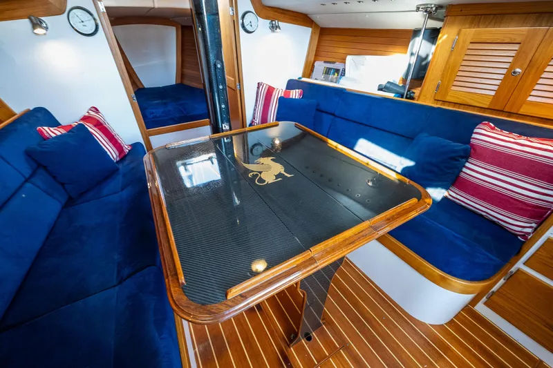 Slide: The Image of Interior of 2007 J Boats J/124 yacht with blue seating and elegant wooden finishes. - 13