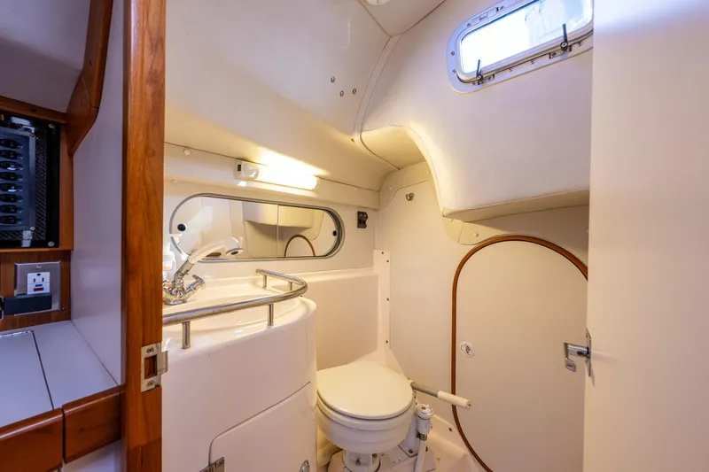 Slide: The Image of 2007 J Boats J/124 yacht bathroom interior with sink, toilet, and mirror. - 17