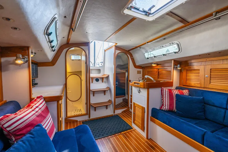 Slide: The Image of Interior of 2007 J Boats J/124 yacht with cozy seating and wooden accents. - 18